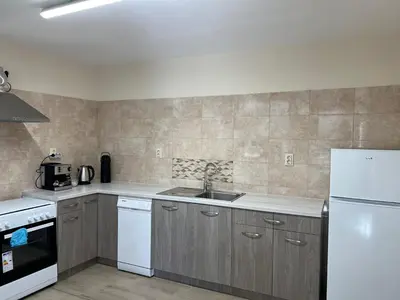 a kitchen with a sink and a white refrigerator at Къща за гости Бадови in Hisarya