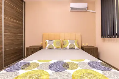 a bedroom with a large bed with a bedspread at Modern and Cozy 1BD in the Top Centre of Plovdiv by Flat Mаnager in Plovdiv