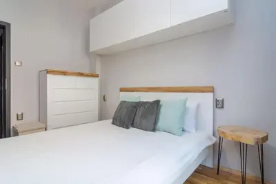 a bedroom with a white bed with blue pillows at Modern design 1 bdrm, 4 guests, Top cente, Near Parliament, Self check-in in Sofia