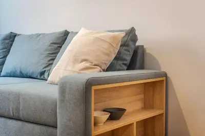 a grey couch with two bowls on top of it at Modern design 1 bdrm, 4 guests, Top cente, Near Parliament, Self check-in in Sofia
