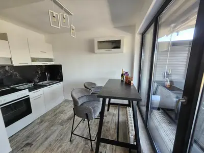 a small kitchen with a table and chairs at V&S Home in Plovdiv
