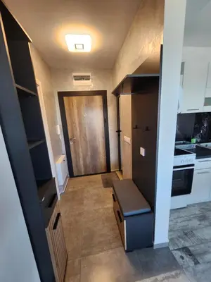 a small kitchen with a refrigerator and a door at V&S Home in Plovdiv