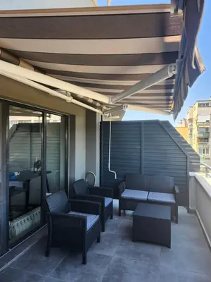 a patio with benches and tables on a building at V&S Home in Plovdiv
