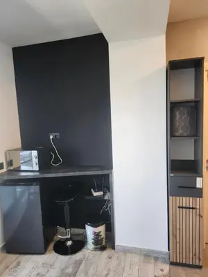 a black desk in a room with a wall at V&S Home in Plovdiv