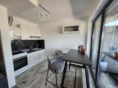a kitchen with a table and chairs in a room at V&S Home in Plovdiv