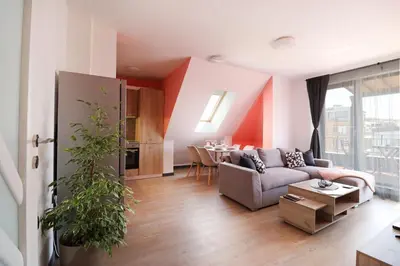 a living room with a couch and a table at New Sofia Skyline 1BDRM Free Parking & Terrace in Sofia