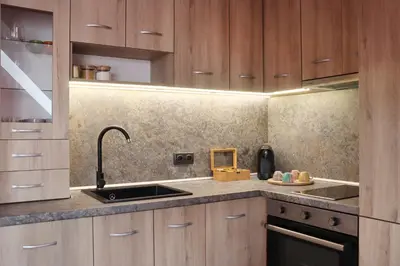 a kitchen with wooden cabinets and a sink at New Sofia Skyline 1BDRM Free Parking & Terrace in Sofia