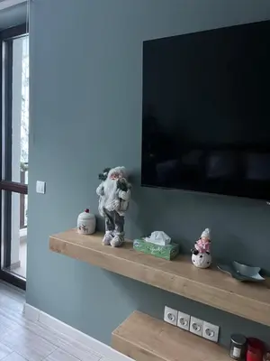 a flat screen tv on a wall with stuffed animals on a shelf at Borovets Gardens Apartment B15 in Borovets