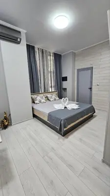 a bedroom with a large bed in a room at Апартаменти за гости Кедър in Sapareva Banya