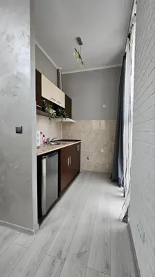 an empty kitchen with a counter and a sink at Апартаменти за гости Кедър in Sapareva Banya