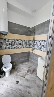 a bathroom with a toilet and a sink at Апартаменти за гости Кедър in Sapareva Banya