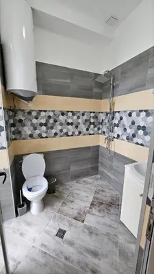 a bathroom with a toilet and a sink at Апартаменти за гости Кедър in Sapareva Banya
