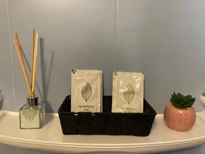 a white table with three boxes of ayurvedic products and chopsticks at Garden apartment in Karlovo
