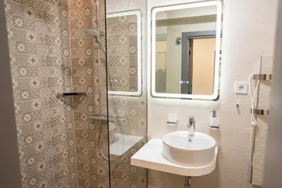 a bathroom with a sink and a shower at Arni Aparts in Velingrad