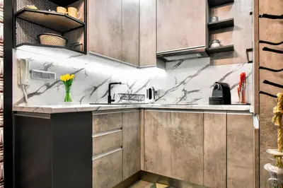 a kitchen with marble counter tops and cabinets at Compact Studio for Digital Nomads, Fast WiFi, AC in Sofia