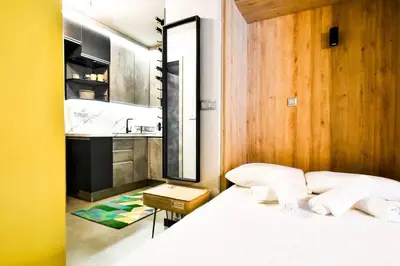 a bedroom with a bed and a sink and a mirror at Compact Studio for Digital Nomads, Fast WiFi, AC in Sofia