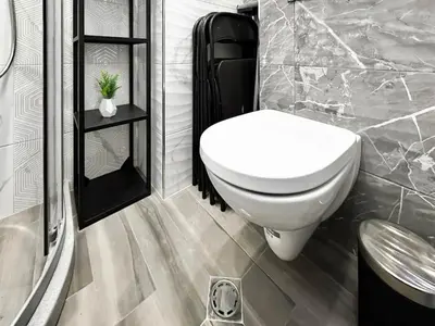 a bathroom with a white toilet and a shower at Compact Studio for Digital Nomads, Fast WiFi, AC in Sofia