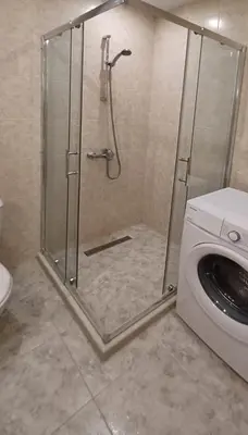 a shower in a bathroom with a washing machine at Апартамент - Студио Престиж 3 in Hisarya