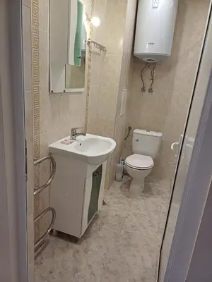 a bathroom with a sink and a toilet at Апартамент - Студио Престиж 3 in Hisarya