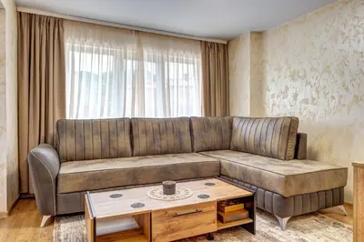 a living room with a couch and a coffee table at Rhodope Escape - Modern 1BR Apartment with Balcony & Free Parking in Smolyan