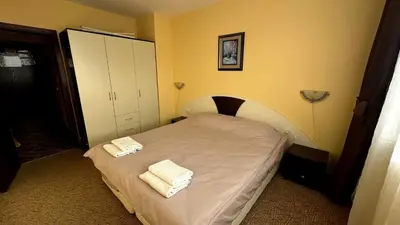 a bedroom with a bed with two towels on it at Апартаменти Хармония in Pamporovo