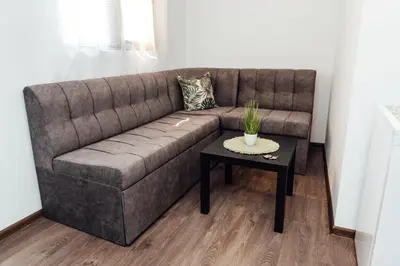 a living room with a couch and a table at Къщи БРИК вила 2 in Sapareva Banya