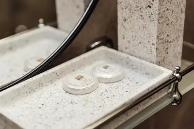 a bathroom sink with two rings in front of a mirror at Къщи БРИК вила 2 in Sapareva Banya