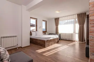 a bedroom with a bed and a large window at Spa Villas Daffi in Smolyan