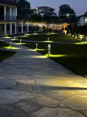 a walkway in front of a building at night at Spa Villas Daffi in Smolyan