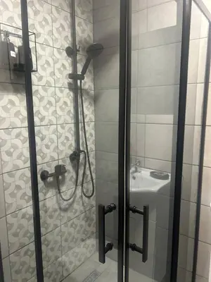 a bathroom with a shower and a sink at Pirotska Cozy Room in Sofia