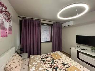 a bedroom with a bed and a flat screen tv at Top Center Retreat, Near AUBG FREE Parking in Blagoevgrad