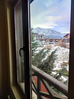 a window with a view of a snow covered mountain at Aspen Apartment A212 3OOm from Gondola in Bansko