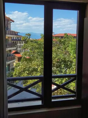 a window with a view of a city at Aspen Apartment A212 3OOm from Gondola in Bansko