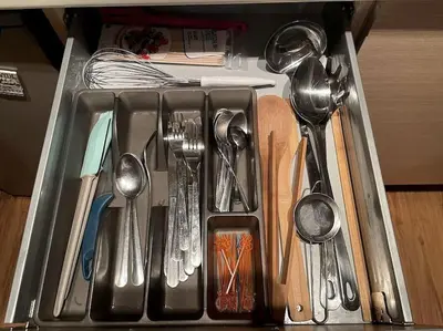 a drawer filled with utensils and spoons at The snug apartment near the brimming mountains in Bansko