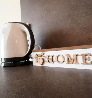 a coffee cup and a sign with the word home at INB Banishora Spot in Sofia