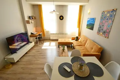 a living room with a couch and a television at Eagle's Spot in Sofia