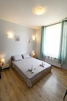 a bedroom with a bed with two towels on it at Eagle's Spot in Sofia