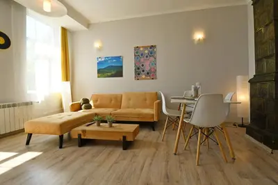 a living room with a couch and a table at Eagle's Spot in Sofia