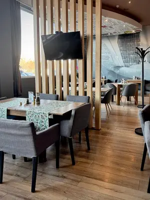 a dining room with a table and chairs at Apartments Sofia Airport free shuttle and parking in Sofia