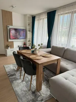a living room with a table and a couch at Anna Lux in Bansko