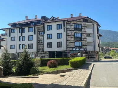 a large white building with a sign on it at Anna Lux in Bansko