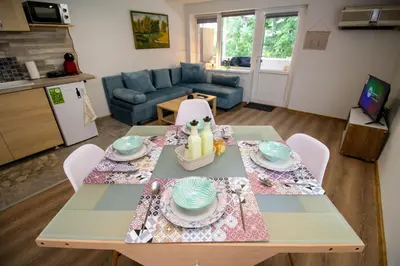 a living room with a dining table and a kitchen at Swan7 Studios in Plovdiv