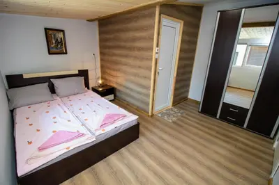 a bedroom with a bed with a wooden wall at Swan7 Studios in Plovdiv