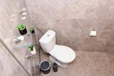 a bathroom with a white toilet and some plants at Swan7 Studios in Plovdiv