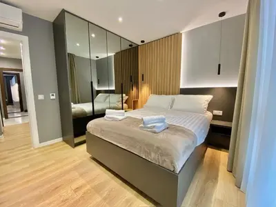 a bedroom with a bed with two towels on it at Gran Capital - Vodolei Park, FREE parking in Sofia