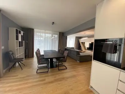 a kitchen and living room with a table and chairs at Gran Capital - Vodolei Park, FREE parking in Sofia