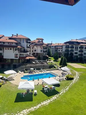 an overhead view of a swimming pool with umbrellas at View Apartment Bansko Royal Towers in Bansko
