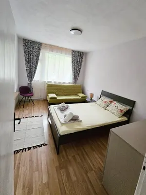 a small room with a bed and a couch at Апартамент Лилия in Gotse Delchev