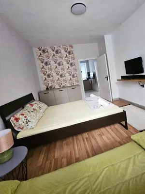 a bedroom with a large bed in a room at Апартамент Лилия in Gotse Delchev