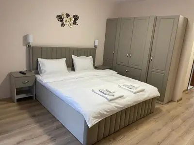 a bedroom with a large bed with white sheets at The Hillside Villa in Ognyanovo